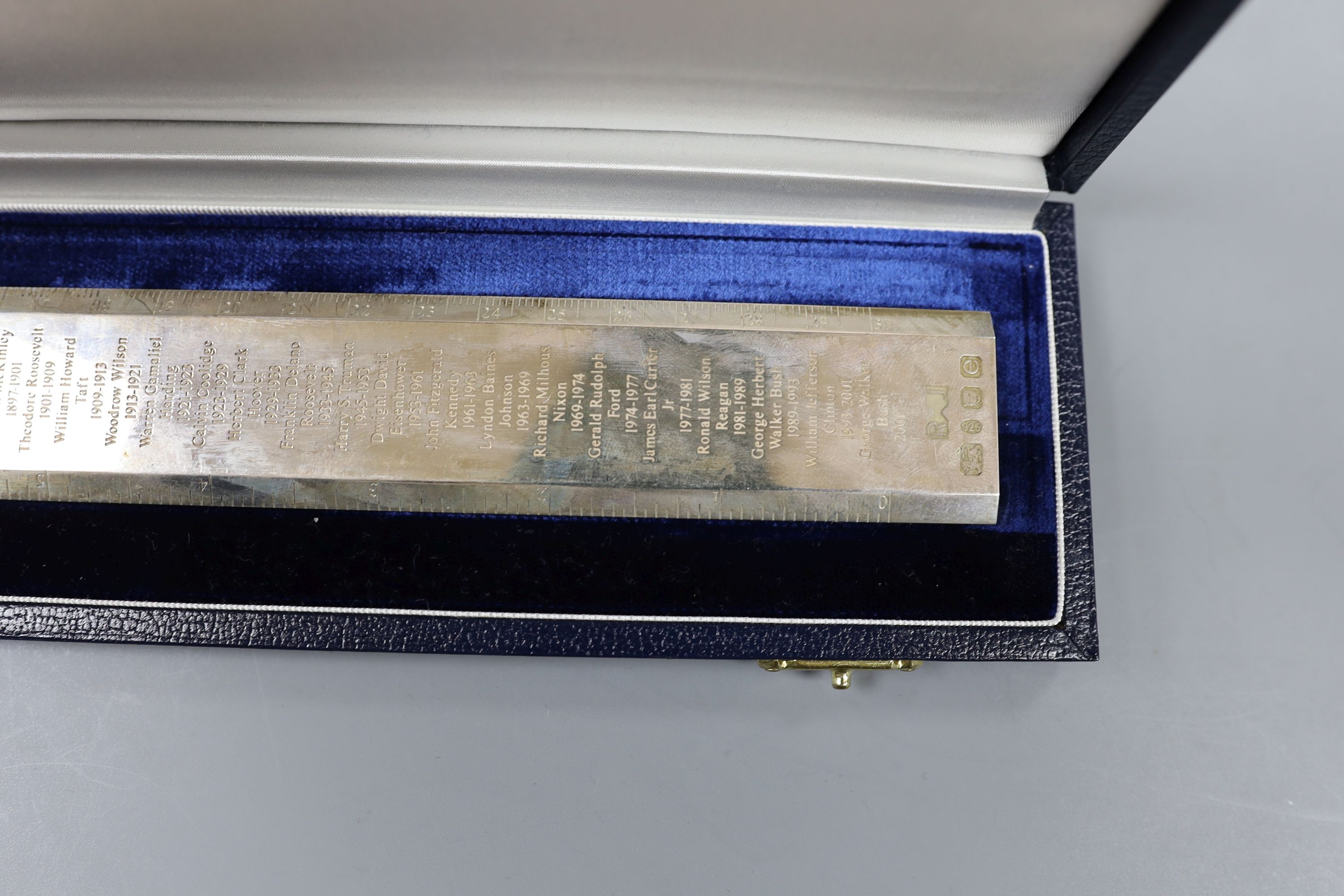 A cased modern silver 'Presidents Rule' ruler, engraved with the names and dates of US Presidents, by Richard Jarvis, London, 2004, 10oz